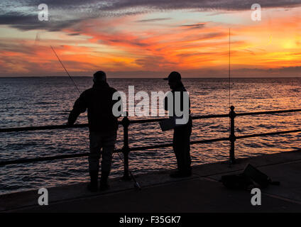 Beautiful sunset at Herne Bay, Kent. Fishermen on Hampton Pier. Stock Photo