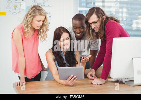 Business team using digital tablet at desk Stock Photo