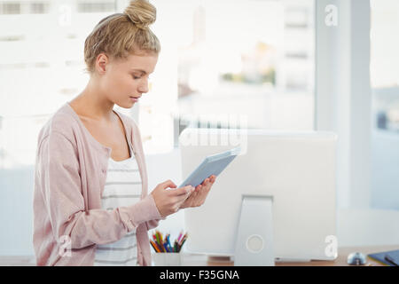 Woman using digital tablet in office Stock Photo