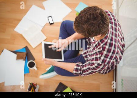 Creative businessman working on digital tablet in office Stock Photo