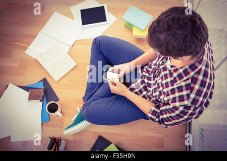 Hipster using smartphone while working in office Stock Photo