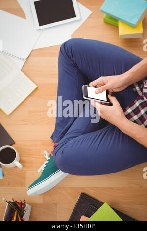 Hipster using smartphone in office Stock Photo