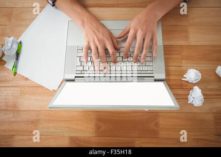 Man working on laptop at desk in office Stock Photo