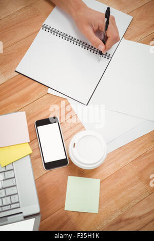 Businessman writing on spiral notebook Stock Photo