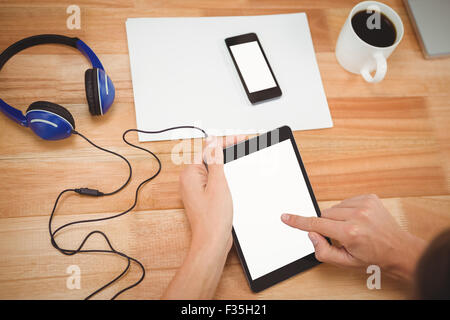 Man using digital tablet with headphones Stock Photo