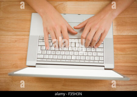 Businessman typing on laptop at desk in office Stock Photo