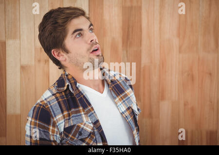 Surprised hipster looking up Stock Photo