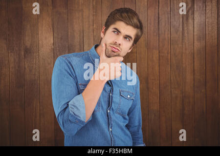 Thoughtful man with hand on chin Stock Photo