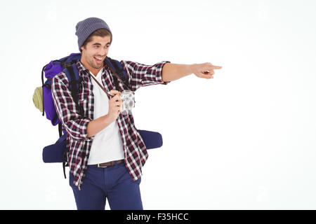 Happy man pointing while holding camera Stock Photo
