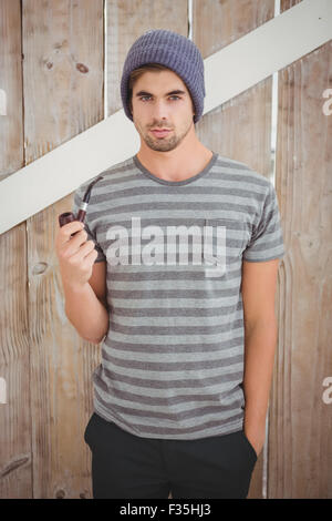 Portrait of man holding smoking pipe Stock Photo