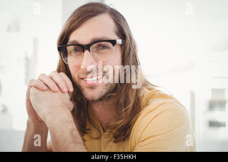 Happy hipster wearing eye glasses in office Stock Photo