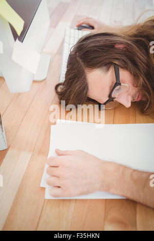 High angle view of tired hipster resting at desk Stock Photo