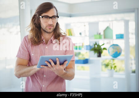 Confident hipster using digital tablet Stock Photo