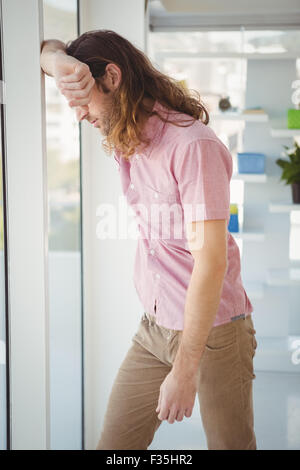 Hipster looking through window Stock Photo