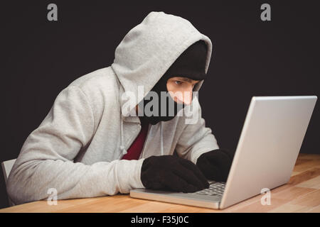 Hacker using laptop Stock Photo