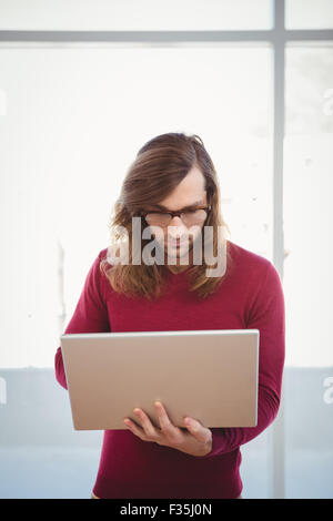 Man using laptop in office Stock Photo
