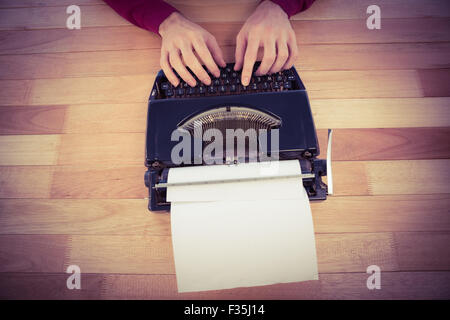 High angle view of man working on typewriter Stock Photo