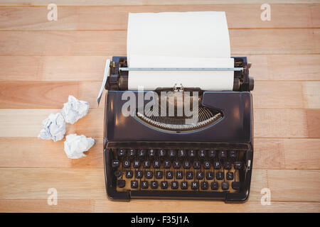Typewriter with paper on table in office Stock Photo