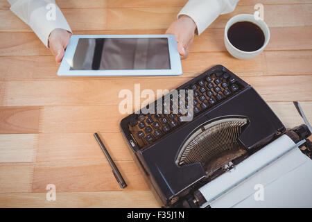 Businessman using digital tablet at desk Stock Photo