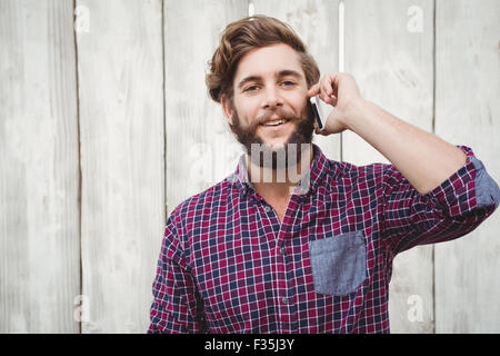 Portrait of hipster using mobile phone Stock Photo