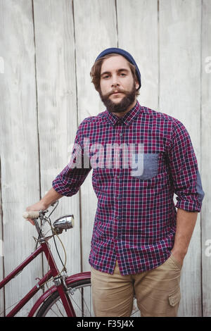 Portrait of confident hipster with bicycle Stock Photo