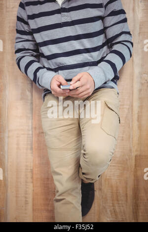 Low section of man using smartphone Stock Photo