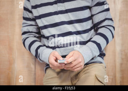 Mid section of man using smartphone Stock Photo
