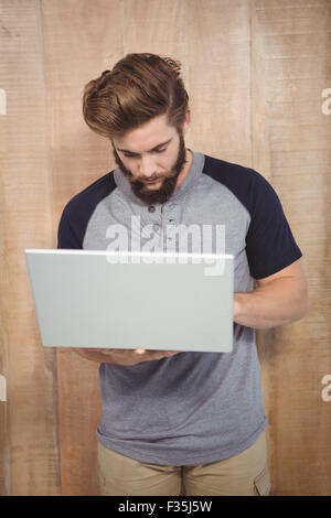 Hipster working on laptop while standing Stock Photo