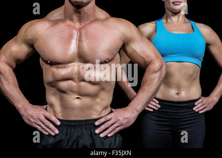 Midsection of man and woman with hands on hip Stock Photo