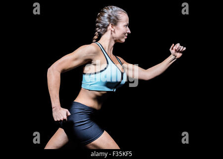 Side view of female athlete running Stock Photo