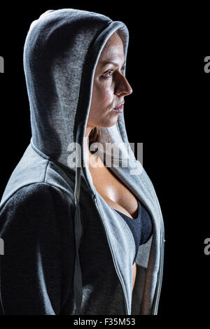 Side view of female athlete in hood Stock Photo