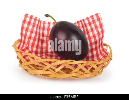 One plum in a basket with a checkered cloth isolated on white background Stock Photo