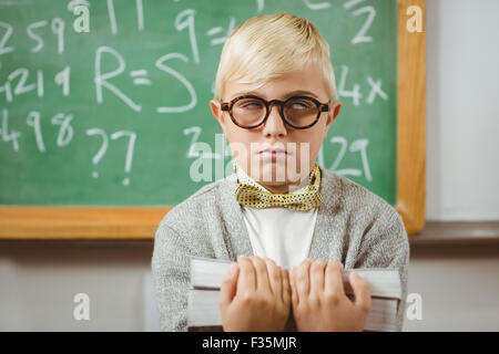 Pupil dressed up as teacher holding books Stock Photo