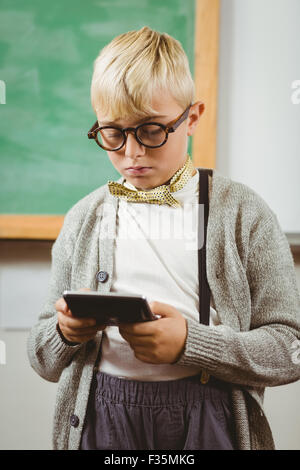 Pupil dressed up as teacher using calculator Stock Photo