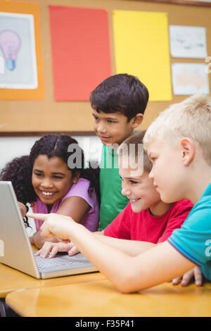 Pupils using a laptop in class Stock Photo