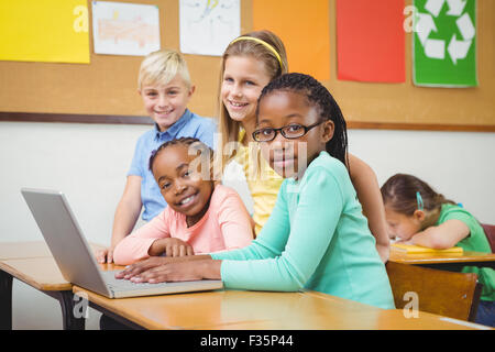 Pupils using a laptop in class Stock Photo