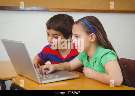 Pupils using a laptop in class Stock Photo