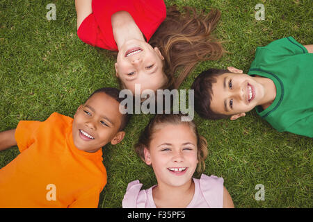 Smiling pupils lying on the ground Stock Photo
