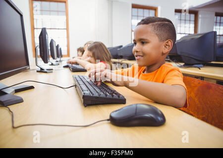 Smiling student using a computer Stock Photo