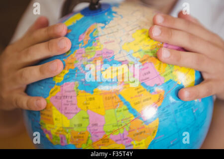 Pupil pointing to a place on a globe Stock Photo - Alamy