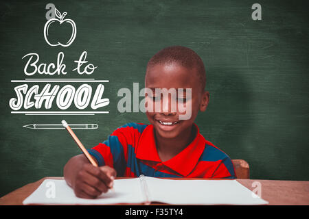Composite image of cute pupil working at her desk Stock Photo - Alamy