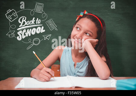 Composite image of cute pupil at desk Stock Photo