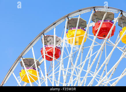 Close up picture of ferris wheel against blue sky in amusement park. Stock Photo