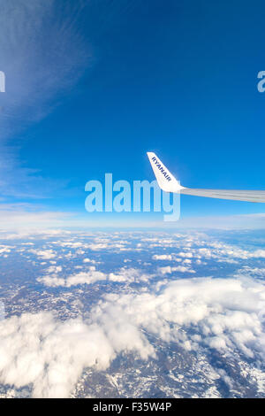 ROME, ITALY - FEBRUARY 21, 2015: Ryanair logo on airplane's wing in mid-air over central Italy. Stock Photo
