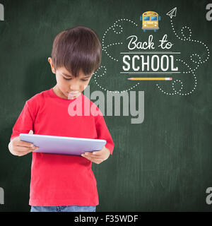 Composite image of cute boy using tablet Stock Photo