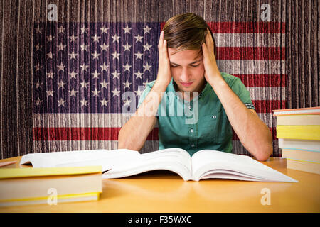 Composite image of student sitting in library reading Stock Photo