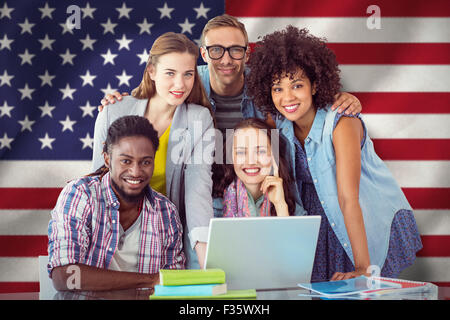 Composite image of fashion students working as a team Stock Photo