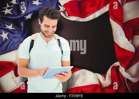 Composite image of student using tablet pc Stock Photo