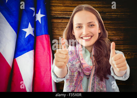 Composite image of woman showing thumbs up Stock Photo