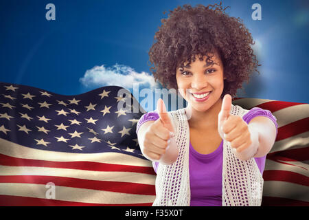 Composite image of smiling woman showing thumbs up Stock Photo